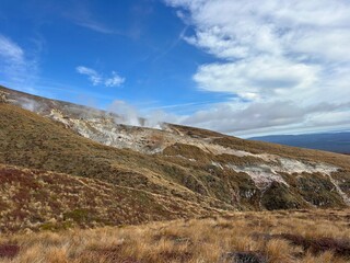 Mountain landscape with drifting clouds near the end of the Tongariro Alpine Crossing in Tongariro National Park, New Zealand. © Katie