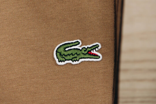 Bordeaux, France - July 14, 2026: Embroidered Lacoste crocodile logo on a garment displayed in the menswear department of Galeries Lafayette