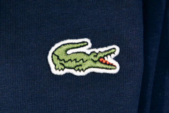 Bordeaux, France - July 14, 2026: Embroidered Lacoste crocodile logo on a garment displayed in the menswear department of Galeries Lafayette