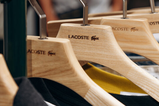 Bordeaux, France - July 14, 2026: Lacoste branded wooden clothes hangers displayed in the menswear department of Galeries Lafayette in central Bordeaux