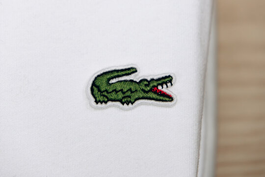 Bordeaux, France - July 14, 2026: Embroidered Lacoste crocodile logo on a garment displayed in the menswear department of Galeries Lafayette