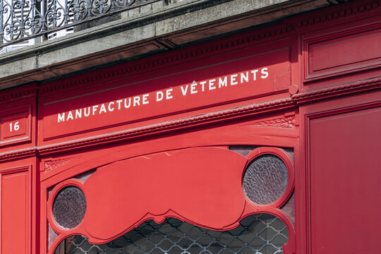 Bordeaux, France - July 14, 2026: Detail of the red facade of the Kidur clothing store with French inscriptions &ldquo;Manufacture de vetements&rdquo; and &ldquo;Fabrique en France&rdquo;