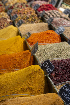 View of colorful mounds of aromatic spices including curry and various herbs displayed in containers at a traditional market in Istanbul, Istanbul, Turkiye.