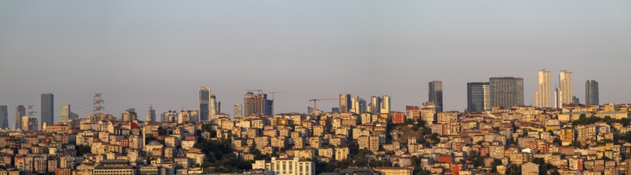View of the modern skyline and dense residential buildings at sunset, with warm golden light illuminating the urban landscape of Istanbul, Istanbul, Turkiye.