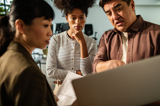 Coworkers discussing project plan in office
