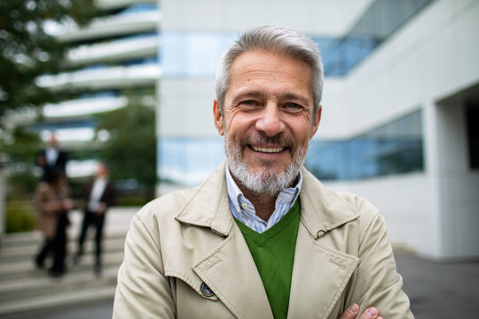 Confident senior businessman portrait outdoors at office