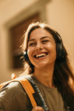 Happy woman listening to music with headphones outdoors