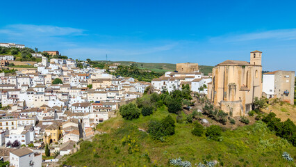 Charming narrow street with traditional white houses and colorful flower pots in Setenil de las Bodegas, Spain. © Maksym