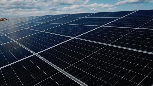 Photovoltaic array reflecting sky and sunlight creates a modern green technology image.