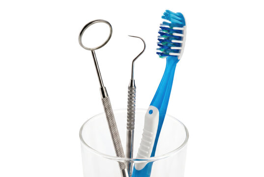 Professional Dental Instruments and Blue Toothbrush in Glass