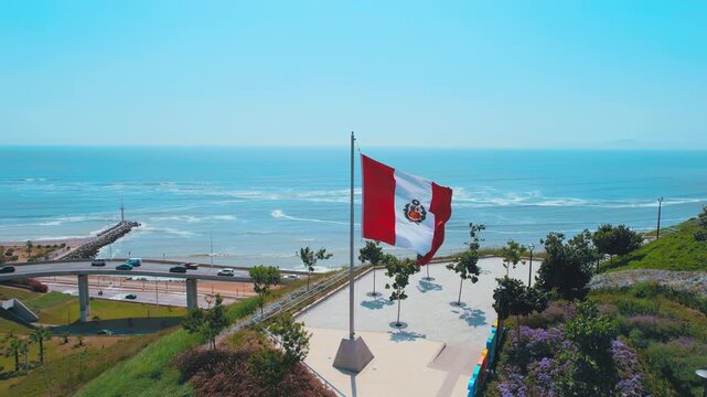 Aerial View of Waving Peruvian Flag over Coastline in Lima Peru