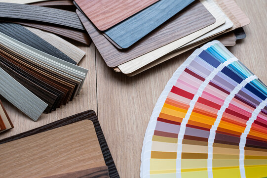Top View of Wooden Laminate Swatches and Paint Palette Guide for Furniture Production Workspace