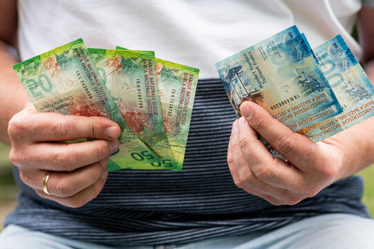 Male Hands Fan Out Swiss Francs Currency Banknotes Stack for Financial Success and Deposit