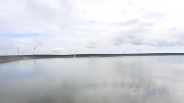 A scenic video view from the high-altitude wind turbine viewpoint at Khao Yai Thiang, Korat, Thailand, featuring beautiful scenery that overlooks the Lam Takhong Dam and wind energy infrastructure.