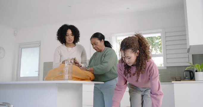 African American family senior, teenage opening orange bag, sorting into PAPER or PLASTIC bins kitch