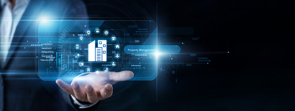 Real estate agent uses a handheld tool to load a virtual screen updating Property Management files. Residential leasing details and maintenance schedules are organized efficiently.