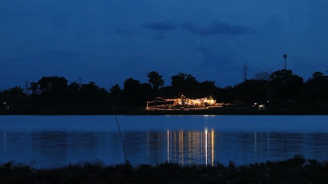 A video view of the atmosphere by a public pond&mdash;featuring lotus flowers and the glow of lights from nearby houses captured while taking a break along the way.