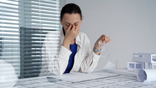 Professional architect or engineer experiencing intense stress and burnout at the office. Feeling overwhelmed by work pressure and deadlines