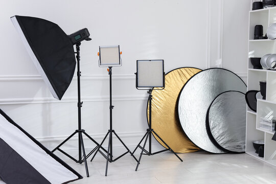 Different modern lighting equipment in photo studio