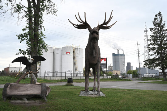 Dryden, ON, Canada - July 1, 2026: Max the Moose and Dryden pulp mill in the background.
