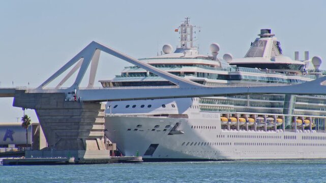 zoomed in shot of giant cruise ship at port vell barcelona