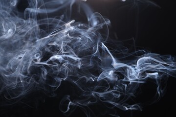 Obraz premium Beautiful smoke in light on black background
