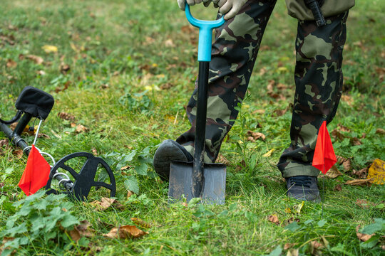 A treasure hunter stands in a lush green field, ready for a treasure hunt