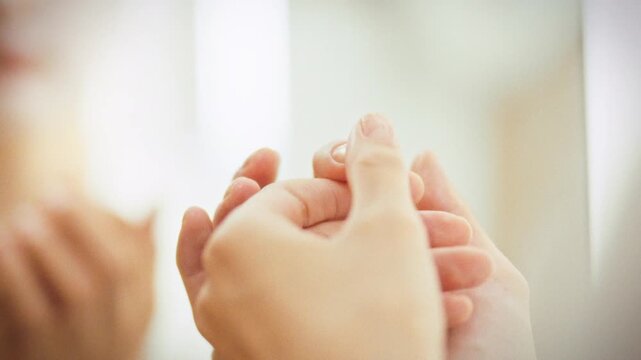 A girl gently massages her fingers' cuticles with a softening agent, a crucial step in daily hand care for nourishing and softening. This process promotes nail beauty and overall hand health