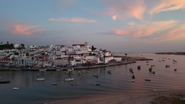 Ferragudo fishing village harbor at sunset