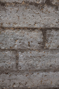 Weathered grey stone wall texture with rough mortar joints and natural aging