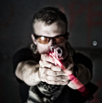 Close-Up of man Target Practicing with laser Sight Pistol