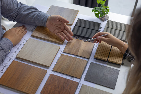 Professionals reviewing different laminate or wood-plastic composite options for a design project.