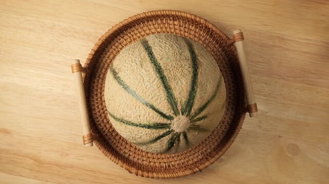 Ripe cantaloupe melon rotating in wicker basket
