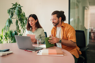Diverse business professionals collaborating on a project during an office meeting, brainstorming...