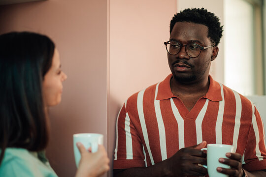 Man and woman enjoying coffee, communicating during a break, fostering teamwork and office connection