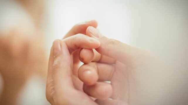 Girl gently massages her cuticle with softening agent, nurturing her nail health. Her hands receive daily care, showcasing vital part of beauty routine that prioritizes cuticle fingertip well-being