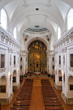 Ornate Church Interior with High Ceiling - A wide-angle shot of a beautiful church interior, featuring elegant vaulted ceilings, wooden pews, and a golden altarpiece at the far end.