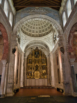 Ornate Golden Altarpiece in Historic Chu - An intricate golden altarpiece stands beneath a beautifully decorated dome ceiling with arches and columns inside a historic European church