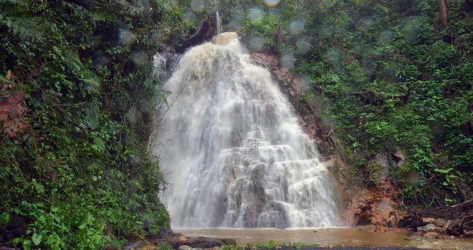 Waterfall on a dangerously flooded river in the Amazon. Rio Narupayacu at 1,200m elevation in the Amazonian foothills of the Andes in Napo province, Ecuador