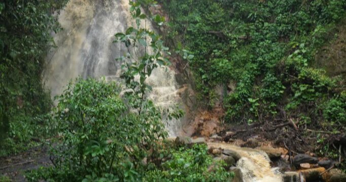 Waterfall on a dangerously flooded river in the Amazon. Rio Narupayacu at 1,200m elevation in the Amazonian foothills of the Andes in Napo province, Ecuador