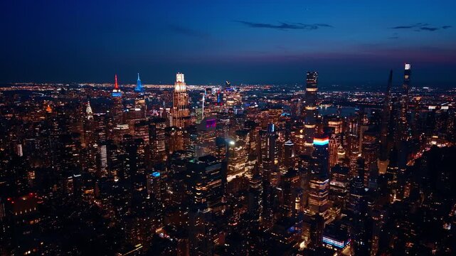 Scenic view on the stunning Manhattan at night. Beautiful lights of New York City from aerial perspective.