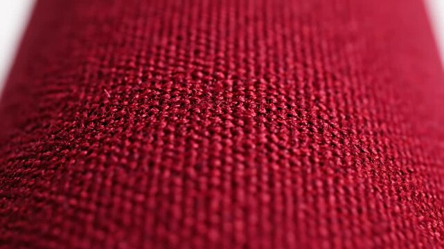 Close-up macro of elegant ruby red fabric textile material with detailed texture and surface pattern