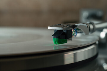 Turntable tonearm with cartridge and stylus tracking vinyl record groove, analog audio playback, hi-fi music technology, audiophile sound and retro listening. © DedMityay