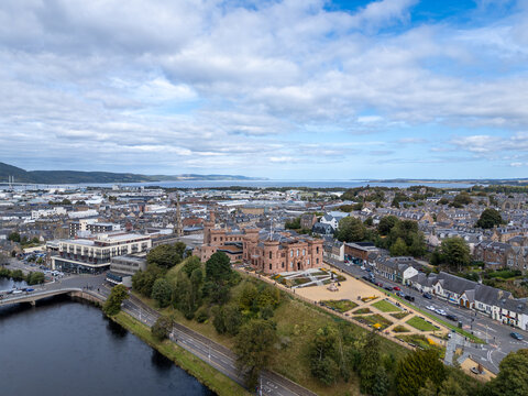 High wide aerial photo of historic Inverness Castle, Castle Esplanade, River Ness, Ness Bridge, and Moray Firth in Inverness, Scottish Highlands, Scotland