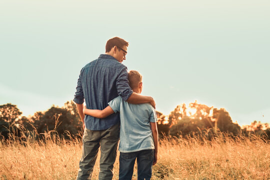Father and Son Embracing at Sunset Concept of Love, Support, Guidance and Fatherhood
