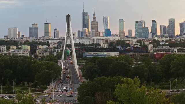 Forward drone flight toward Vistula River and Warsaw skyline at golden hour, approaching cable-stayed bridge with skyscrapers and downtown architecture in cinematic aerial view