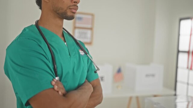 Man doctor in green scrubs with stethoscope, arms crossed at polling station wearing vote sticker; civic duty pride.