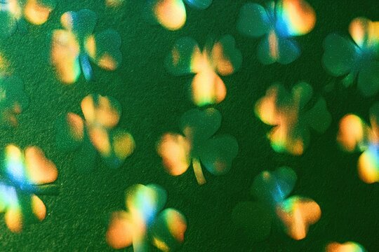 Blurry green shamrocks with rainbow-like light effects