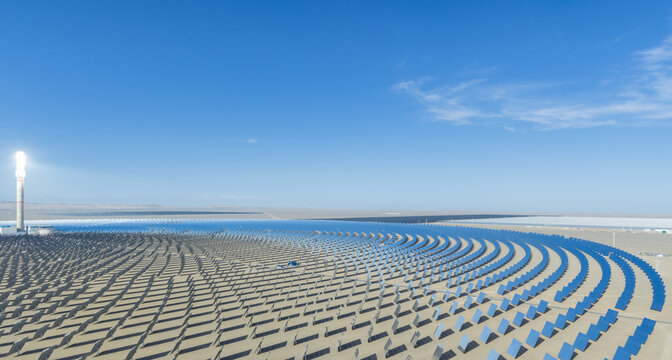 Aerial View of Molten Salt Concentrated Solar Power Plant with Glowing Receiver Tower and Vast Heliostat Mirror Array in Gobi Desert