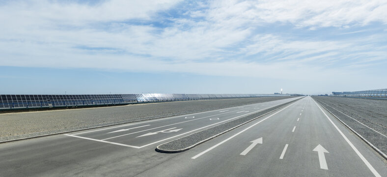 Empty Asphalt Highway Stretching Through Gobi Desert Solar Park